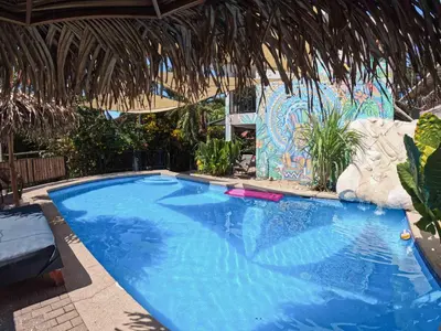 a large blue swimming pool in a resort at La Posada - Hostel in Santa Teresa Beach