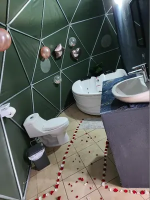 a bathroom with a toilet and a sink and a tub at Cabaña del Lago in Cuatro Esquinas
