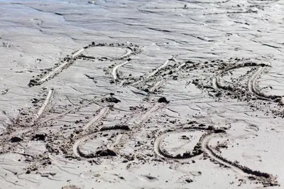 an inscription written in the sand on the beach at Boutique Hotel Luna Azul in Playa Ostional
