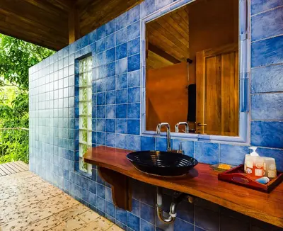 a bathroom with a sink and a mirror at Boutique Hotel Luna Azul in Playa Ostional