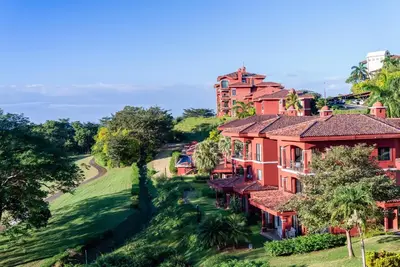 an aerial view of a house with a golf course at Designer Penthouse - Bougainvillea - Reserva Conchal Golf Resortl in Playa Conchal