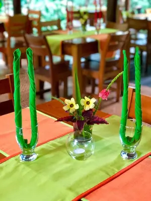two vases with flowers in them on a table at Arenal Oasis Eco Lodge & Wildlife Refuge in Fortuna
