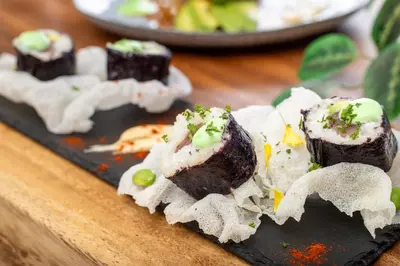 a plate of food with sushi on a table at Pacific Kalokairi - Adults Only in Tamarindo