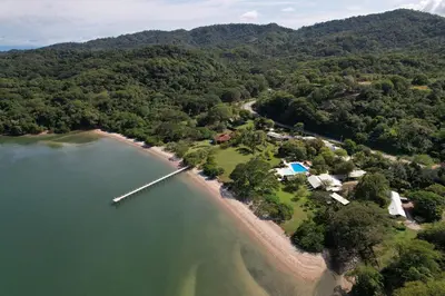an aerial view of a beach with a house and a dock at OPacifico Hotel Boutique in Playa Naranjo