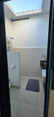 a bathroom with a toilet and a sink and a window at Volcano Panoramic Views in Vara Blanca