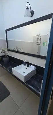a bathroom with a white sink and a mirror at Volcano Panoramic Views in Vara Blanca