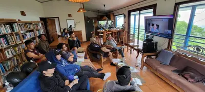 a group of people sitting in a living room watching a tv at Volcano Panoramic Views in Vara Blanca