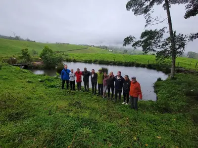 a group of people standing in front of a lake at Volcano Panoramic Views in Vara Blanca
