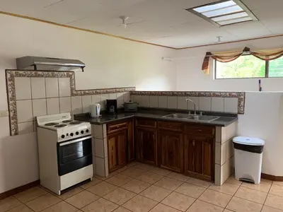 a kitchen with a stove and a sink at Globi Lodge #4 in Monteverde Costa Rica