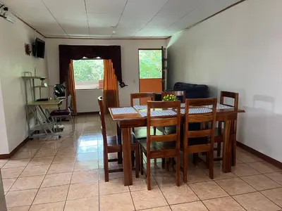a dining room with a wooden table and chairs at Globi Lodge #4 in Monteverde Costa Rica