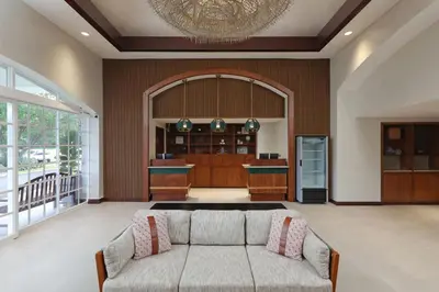 a living room with a couch and a kitchen at Four Points by Sheraton San Jose Costa Rica in San José