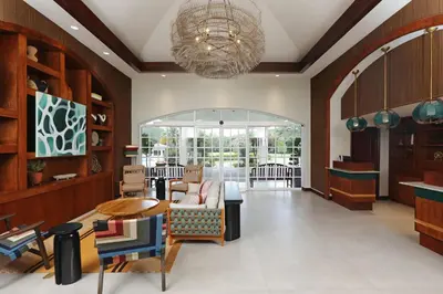a living room with a couch and chairs and a chandelier at Four Points by Sheraton San Jose Costa Rica in San José