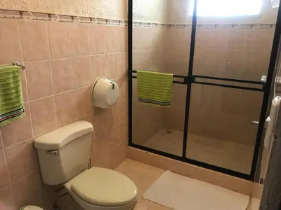 a bathroom with a toilet and a shower at Casa del Suizo in Alajuela City