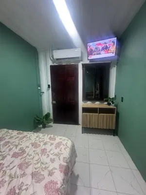 a bedroom with a bed and a fish tank at The Jungle Container in Quepos
