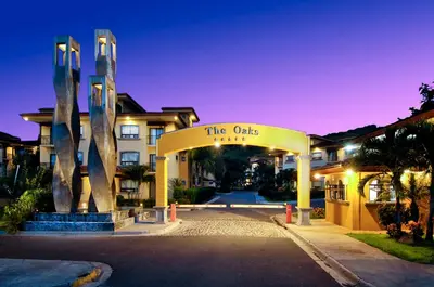 a building with a sign that reads the oaks at The Oaks Tamarindo Pool Front Condominiums fast wifi in Tamarindo
