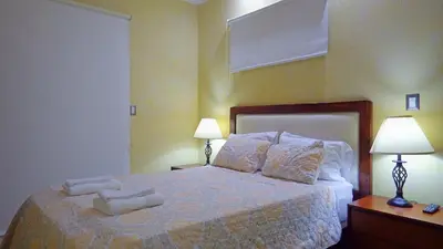 a bedroom with a bed with two towels on it at The Oaks Tamarindo Pool Front Condominiums fast wifi in Tamarindo