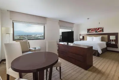 a large hotel room with a bed and a table at Wyndham Garden San Jose Escazu, Costa Rica in San José