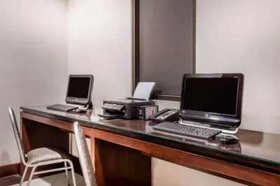 a desk with a laptop computer and a printer at Wyndham Garden San Jose Escazu, Costa Rica in San José