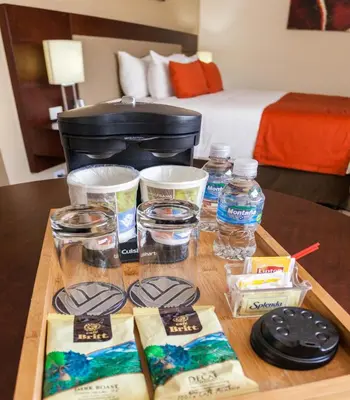 a table with a tray of food and bottles of water at Wyndham Garden San Jose Escazu, Costa Rica in San José