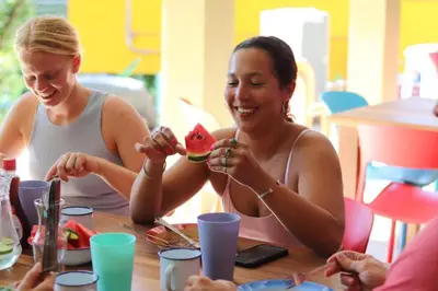a group of women sitting at a table eating food at Planet B Hostel - Adults Only in Manuel Antonio