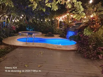 a swimming pool in a garden at night at San Gabriel Apartments in Fortuna