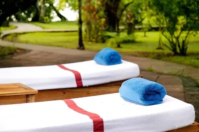 two beds with blue hats on top of them at Tortuga Lodge in Tortuguero
