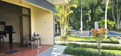 a hotel room with a desk and a view of a garden at Hotel Monte Real in Fortuna