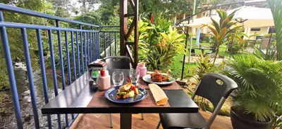 a table with two plates of food on a balcony at Hotel Monte Real in Fortuna