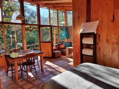 a bedroom with a bed and a desk and a table at Finca Terra Viva in Monteverde Costa Rica
