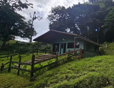 a small house in a field with a fence at Finca Terra Viva in Monteverde Costa Rica