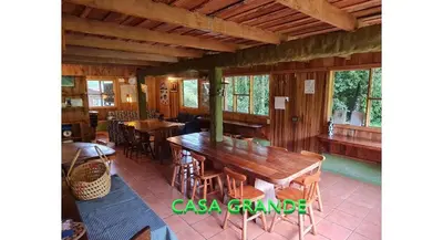 a dining room with a wooden table and chairs at Finca Terra Viva in Monteverde Costa Rica