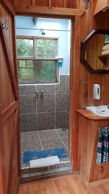 a bathroom with a shower with a glass door at Finca Terra Viva in Monteverde Costa Rica