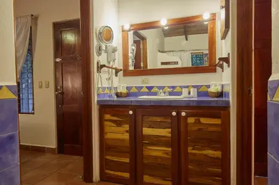 a bathroom with a sink and a mirror at Living Hotel in Nosara