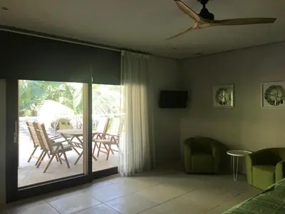 a living room with a sliding glass door to a patio at Casa Papito in Potrero