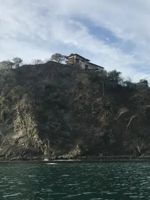 a house on top of a hill on the water at Casa Papito in Potrero