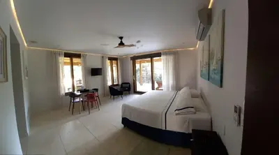 a bedroom with a bed and a table and chairs at Casa Papito in Potrero