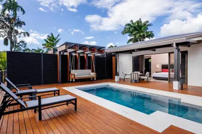 a house with a swimming pool and a bedroom at Arenal Manoa Resort & Hot Springs in Fortuna