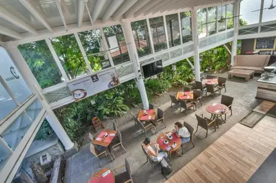 an overhead view of a restaurant with people sitting at tables at La Riviera Hotel in San José