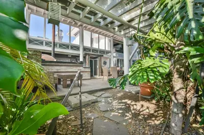 a conservatory with a table and a bunch of plants at La Riviera Hotel in San José