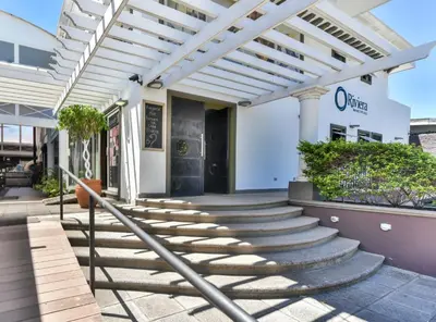 a building with stairs in front of it at La Riviera Hotel in San José