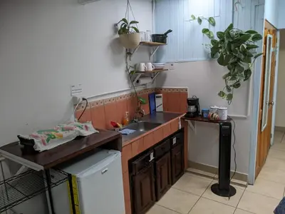a small kitchen with a sink and a dishwasher at Guesthouse Casa Lapa2 in Alajuela City
