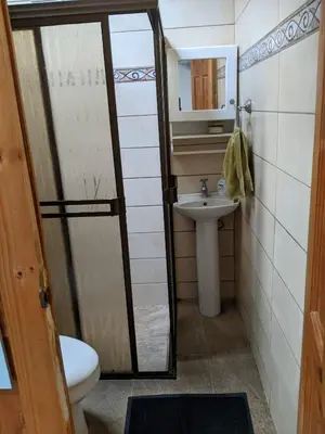 a bathroom with a sink and a toilet and a mirror at Guesthouse Casa Lapa2 in Alajuela City