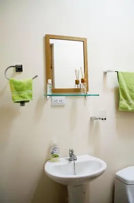a bathroom with a sink and a mirror and a toilet at Guesthouse Casa Lapa2 in Alajuela City