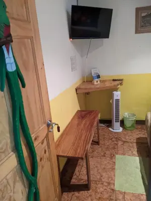 a room with a door and a table and a desk at Guesthouse Casa Lapa2 in Alajuela City