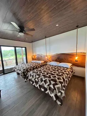 a bedroom with two beds and a ceiling fan at Monteverde Ecolove in Monteverde Costa Rica