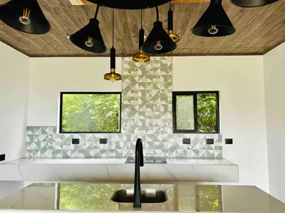 a kitchen with black pendant lights and a sink at Monteverde Ecolove in Monteverde Costa Rica