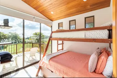 a bedroom with two bunk beds and a balcony at Puma Meraki Mountain View Monteverde in Monteverde Costa Rica