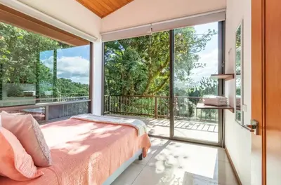a bedroom with a bed and a large window at Puma Meraki Mountain View Monteverde in Monteverde Costa Rica
