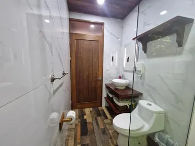a bathroom with a toilet and a sink at Puma Meraki Mountain View Monteverde in Monteverde Costa Rica
