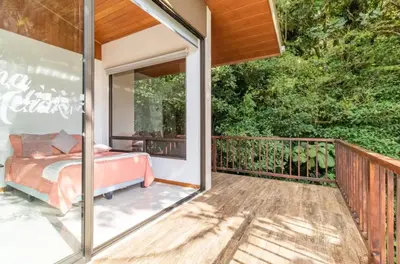 a bedroom on the deck of a house at Puma Meraki Mountain View Monteverde in Monteverde Costa Rica